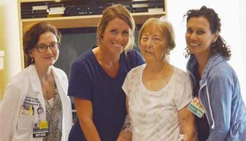 Mary standing with her rehabilitation team.